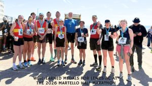 well-earned medals for Lewes AC at The 2026 Martello Half Marathon